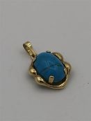 A 14ct yellow gold pendant with blue agate stone