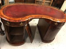 A Ladies mahogany and leather topped writing desk, in kidney shape.