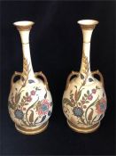 A pair of Royal Doulton vases, one with extensive repairs