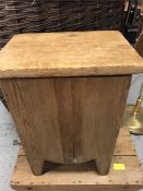 An antique pine stool or storage bin with brass cup handles.