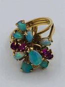 A 14ct yellow gold ruby and opal cluster ring.