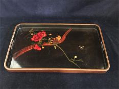 A Chinese lacquered tray with songbird and floral design.