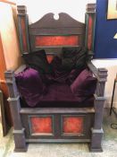 A large throne with cushions, from the set of the movie Dragon Slayer