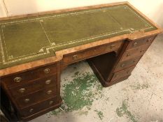 A walnut pedestal desk four drawers to either side with a central drawer
