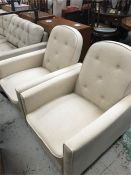 A pair of light cream reclining chairs