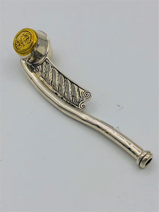 A silver two tone Bosons whistle