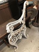Two white cast iron bench ends