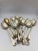 A set of twelve spoons by WH & Sons Ltd (940g)