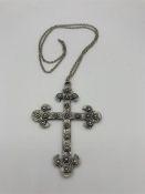 A White metal cross on chain