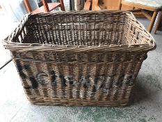 A large wicker laundry basket with Schweppes on the side.