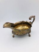 A silver sauce or gravy boat on three feet in hoof form, possibly London 1826