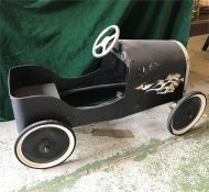 A Vintage pedal car in black