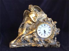 A clock in resin with angelic figure.