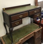 A Four drawer leather topped writing desk