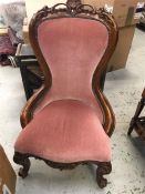 A Low large chair in pink fabric with beaded finish.
