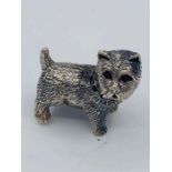 A silver cast figure of a dog