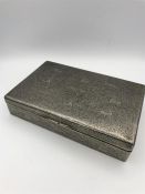 An Indian silver cigarette box with animal themed engraving.