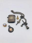 A silver albert chain, vesta case and assorted charms.