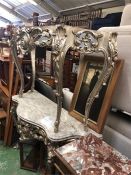 A pair of marble topped hall or console tables with carved legs in silver.