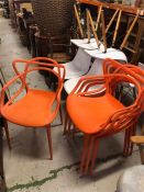 A set of four designer retro looking Orange chairs