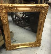 A Large gilt mirror 130cm wide by 107 cm high.