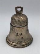 A silver inkwell in the form of a bell, monogrammed DG, hallmarked Birmingham by William Neale.