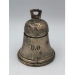 A silver inkwell in the form of a bell, monogrammed DG, hallmarked Birmingham by William Neale.