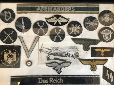 A selection of German WWII military badges, insignia and memorabilia framed, full list Verso. To