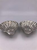 A Pair of silver butter dishes in the form of scallop shells, hallmarked Birmingham 1910 , makers