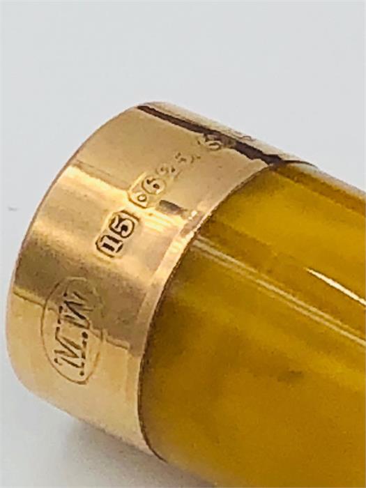 An Amber cigar holder with a 9ct gold mount