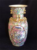 A large Chinese Famille Rose vase with gilded handles