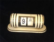 A retro mid century clock in white.