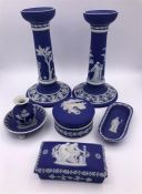 A selection of dark blue Wedgwood Jasperware to include two candlesticks.