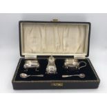 A Cased cruet set hallmarked Birmingham 1953/54