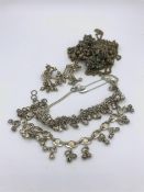 A selection of Indian silver to include anklets, earrings and Sari fastners.