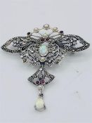 A silver Butterfly brooch set with ruby, pearls and opals.