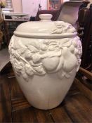 A large white pot with grape and vine design.