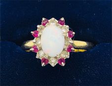 An Opal, diamond and ruby ring on 18ct gold setting.