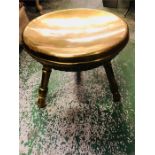 A brass three legged stool