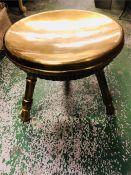 A brass three legged stool