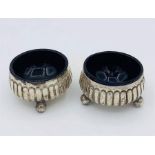 A pair of hallmarked silver salts with blue liners