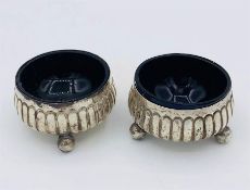 A pair of hallmarked silver salts with blue liners