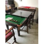 An Antique snooker/dining table with chairs red leather seat pads.