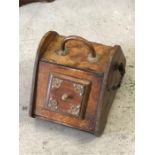 A coal scuttle in wood with brass fitments