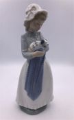 Nao figure of a girl holding a puppy in a blanket