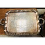 A heavy ornate white metal engraved tray with decorative edges and handles
