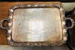 A heavy ornate white metal engraved tray with decorative edges and handles