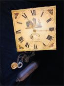 A Longcase clock face and weights.