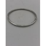 A silver bangle set with a row of CZ's