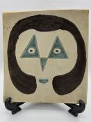 A raised plate of platter decorated with a woman's face, a mid century piece by Indian Artist